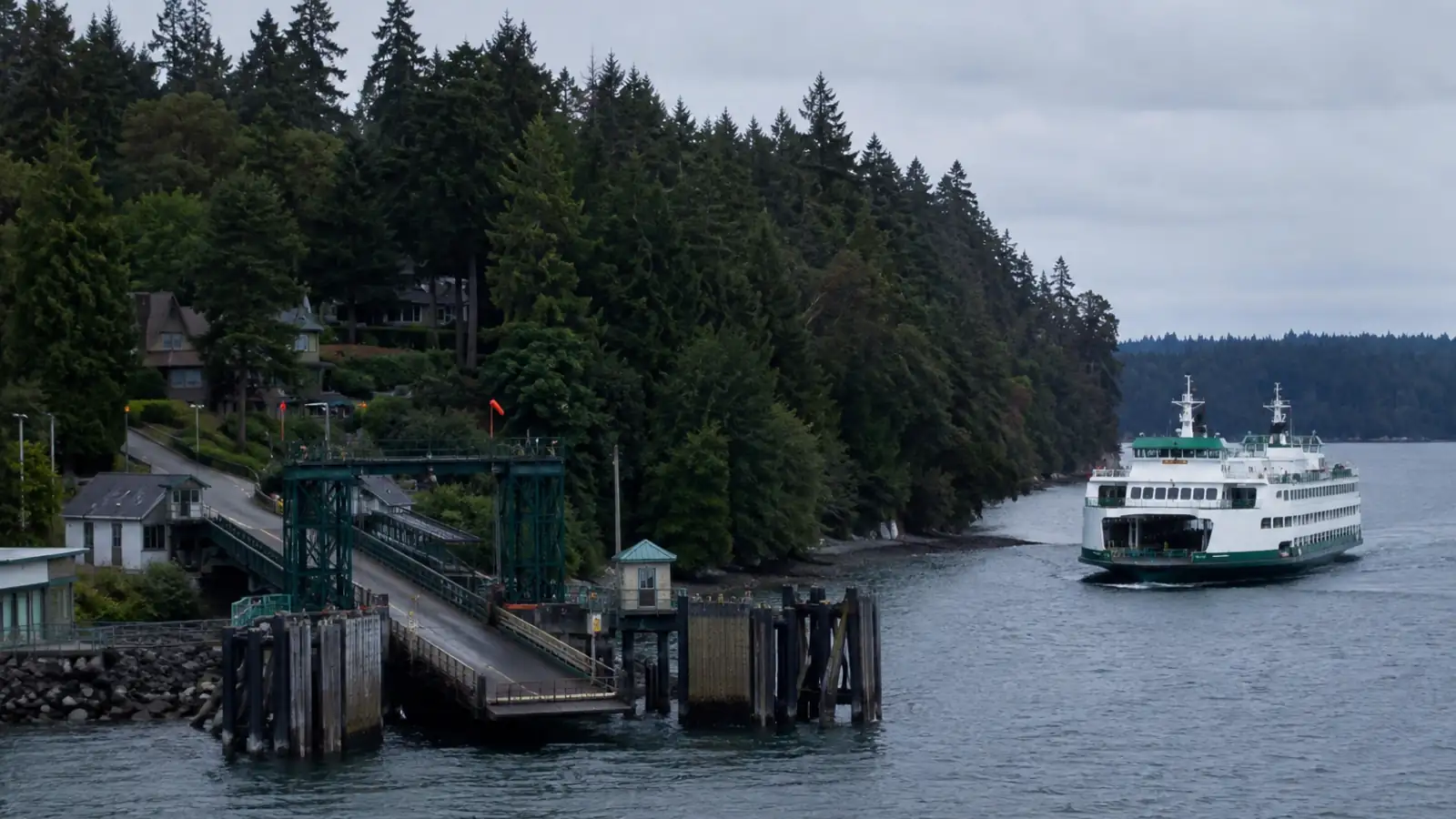 A small ferry terminal tucked into a wooded residential shoreline